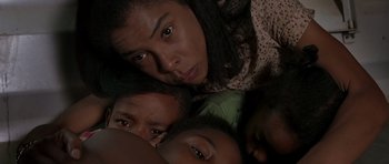 Movie still from “Hotel Rwanda” (2004), directed by Terry George – A group of people that are laying on the ground; Close Up shot, Overhead angle