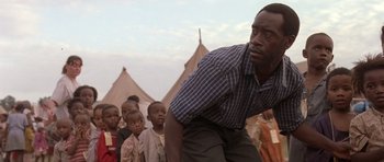 Movie still from “Hotel Rwanda” (2004), directed by Terry George – A group of people standing in front of a tent; Close Up shot, Low angle