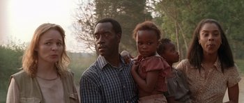 Movie still from “Hotel Rwanda” (2004), directed by Terry George – A man holding a little girl in his arms; Close Up shot, Low angle