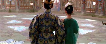Movie still from “House of Flying Daggers” (2004), directed by Yimou Zhang – Two women dressed in traditional chinese clothing looking out at a building; Medium shot, Over the shoulder angle