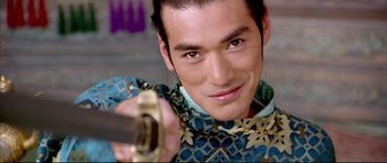 Movie still from “House of Flying Daggers” (2004), directed by Yimou Zhang – A person holding a gun pointed at the camera; Close Up shot, Over the shoulder angle