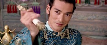 Movie still from “House of Flying Daggers” (2004), directed by Yimou Zhang – A person holding a piece of food; Close Up shot, Over the shoulder angle