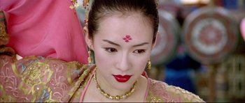 Movie still from “House of Flying Daggers” (2004), directed by Yimou Zhang – A woman in a traditional chinese dress with a red flower on her forehead; Close Up shot, Over the shoulder angle