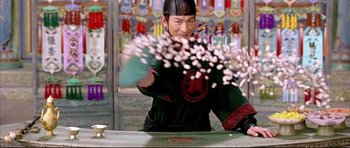 Movie still from “House of Flying Daggers” (2004), directed by Yimou Zhang – A man in a black hat and a black shirt; Medium shot, Low angle