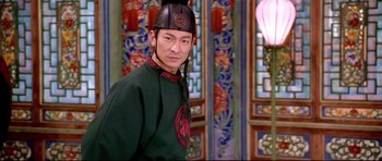 Movie still from “House of Flying Daggers” (2004), directed by Yimou Zhang – A man wearing a black hat and a green shirt; Medium shot, Over the shoulder angle
