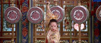 Movie still from “House of Flying Daggers” (2004), directed by Yimou Zhang – A woman in oriental garb is performing a dance; Medium shot, Low angle