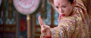 Movie still from “House of Flying Daggers” (2004), directed by Yimou Zhang – A woman in a kimono is doing a hand gesture; Close Up shot, Low angle