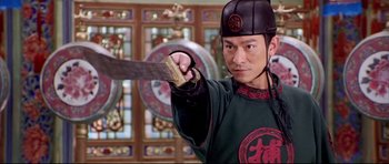 Movie still from “House of Flying Daggers” (2004), directed by Yimou Zhang – A man holding a sword in front of stained glass windows; Close Up shot, Low angle