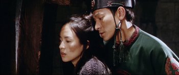 Movie still from “House of Flying Daggers” (2004), directed by Yimou Zhang – A man and a woman standing next to each other; Close Up shot, Low angle