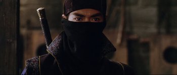 Movie still from “House of Flying Daggers” (2004), directed by Yimou Zhang – A man with a black mask on his face; Close Up shot, Low angle