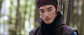 Movie still from “House of Flying Daggers” (2004), directed by Yimou Zhang – A person wearing a suit and hat; Close Up shot, Over the shoulder angle