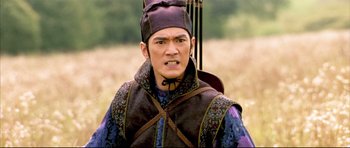 Movie still from “House of Flying Daggers” (2004), directed by Yimou Zhang – A man wearing a hat and a purple vest; Close Up shot, Over the shoulder angle