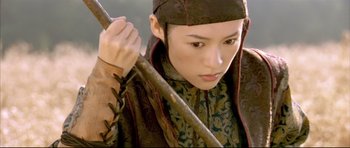 Movie still from “House of Flying Daggers” (2004), directed by Yimou Zhang – A person holding a stick in their hands; Medium shot, Low angle