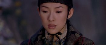 Movie still from “House of Flying Daggers” (2004), directed by Yimou Zhang – A person wearing a hat; Close Up shot, Over the shoulder angle