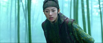 Movie still from “House of Flying Daggers” (2004), directed by Yimou Zhang – A woman in a green outfit looking to her left; Medium shot, Low angle