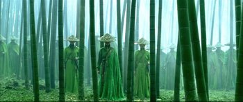 Movie still from “House of Flying Daggers” (2004), directed by Yimou Zhang – A group of people standing next to each other in a forest; Wide shot, Low angle