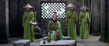 Movie still from “House of Flying Daggers” (2004), directed by Yimou Zhang – A group of people dressed in ancient clothing and hats; Wide shot, High angle
