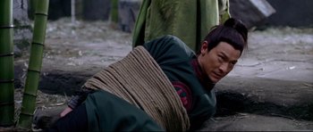 Movie still from “House of Flying Daggers” (2004), directed by Yimou Zhang – A man tied to the ground with a rope around his neck; Close Up shot, High angle