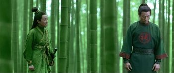 Movie still from “House of Flying Daggers” (2004), directed by Yimou Zhang – Two people standing in the middle of a bamboo forest; Medium shot, Low angle