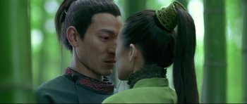 Movie still from “House of Flying Daggers” (2004), directed by Yimou Zhang – A man and a woman face to face in a forest; Close Up shot, Over the shoulder angle