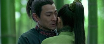 Movie still from “House of Flying Daggers” (2004), directed by Yimou Zhang – A man and a woman are kissing in a forest; Close Up shot, Over the shoulder angle