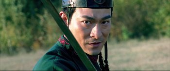 Movie still from “House of Flying Daggers” (2004), directed by Yimou Zhang – A person wearing a hat and holding a sword; Close Up shot, Low angle