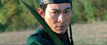 Movie still from “House of Flying Daggers” (2004), directed by Yimou Zhang – A person holding a stick; Close Up shot, Over the shoulder angle