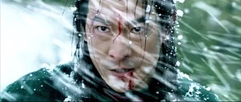 Movie still from “House of Flying Daggers” (2004), directed by Yimou Zhang – A person with blood on their face; Close Up shot, Low angle