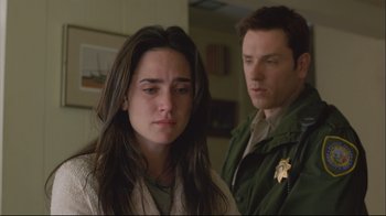 Movie still from “House of Sand and Fog” (2003), directed by Vadim Perelman – A man and a woman standing next to each other; Close Up shot, Over the shoulder angle