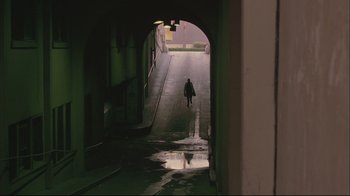 Movie still from “House of Sand and Fog” (2003), directed by Vadim Perelman – A person is walking down a tunnel in the dark; Extreme Wide shot, High angle