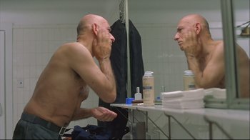 Movie still from “House of Sand and Fog” (2003), directed by Vadim Perelman – A bald man looking at himself in the mirror; Close Up shot, Low angle