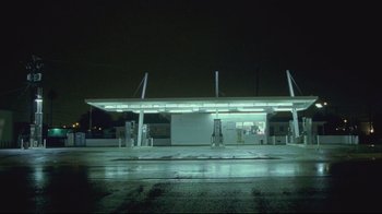 Movie still from “House of Sand and Fog” (2003), directed by Vadim Perelman – An empty gas station at night with lights on; Extreme Wide shot, Low angle