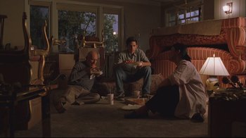 Movie still from “House of Sand and Fog” (2003), directed by Vadim Perelman – A group of people sitting on the floor eating food; Wide shot, High angle