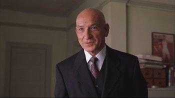 Movie still from “House of Sand and Fog” (2003), directed by Vadim Perelman – A man in a suit and tie standing in front of a wall; Close Up shot, Low angle