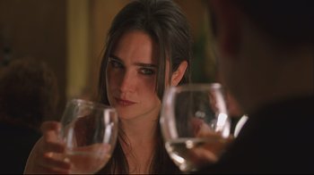 Movie still from “House of Sand and Fog” (2003), directed by Vadim Perelman – A woman sitting in front of a man holding a wine glass; Close Up shot, Over the shoulder angle