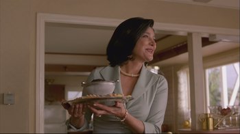 Movie still from “House of Sand and Fog” (2003), directed by Vadim Perelman – A woman holding a plate with a bowl on it; Medium shot, Low angle
