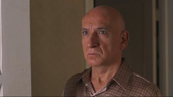 Movie still from “House of Sand and Fog” (2003), directed by Vadim Perelman – An older bald man wearing a plaid shirt; Close Up shot, Low angle