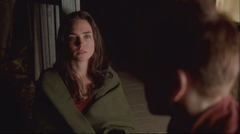 Movie still from “House of Sand and Fog” (2003), directed by Vadim Perelman – A woman wrapped in a blanket sitting on the ground; Close Up shot, Over the shoulder angle