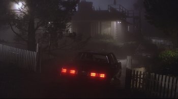 Movie still from “House of Sand and Fog” (2003), directed by Vadim Perelman – A car is parked on the side of the road in the dark; Extreme Wide shot, Low angle