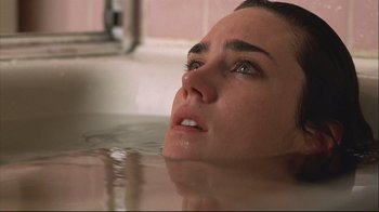 Movie still from “House of Sand and Fog” (2003), directed by Vadim Perelman – A person laying in a tub of water; Close Up shot, High angle