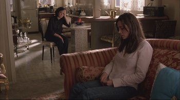 Movie still from “House of Sand and Fog” (2003), directed by Vadim Perelman – Two people sitting on a couch in a room; Wide shot, High angle