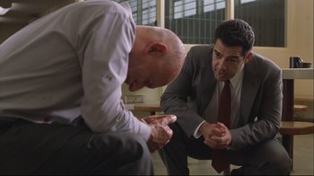 Movie still from “House of Sand and Fog” (2003), directed by Vadim Perelman – Two men in business suits sitting next to each other; Medium shot, Low angle