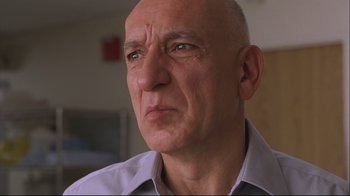 Movie still from “House of Sand and Fog” (2003), directed by Vadim Perelman – An older man with a bald head looking at the camera; Close Up shot, Low angle