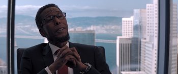 Movie still from “Venom” (2018), directed by Ruben Fleischer – A man in a suit and a red neck tie; Close Up shot, Over the shoulder angle