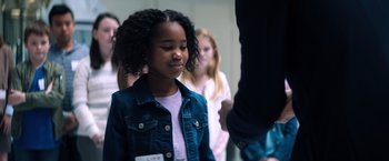 Movie still from “Venom” (2018), directed by Ruben Fleischer – A girl in a denim jacket is looking at the camera; Medium shot, Over the shoulder angle