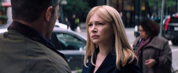 Movie still from “Venom” (2018), directed by Ruben Fleischer – A woman in a business suit on the street; Close Up shot, Over the shoulder angle
