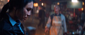 Movie still from “Venom” (2018), directed by Ruben Fleischer – A person in a dark room; Close Up shot, Over the shoulder angle