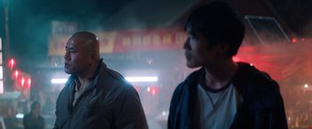 Movie still from “Venom” (2018), directed by Ruben Fleischer – Two men standing next to each other on a city street; Close Up shot, Over the shoulder angle