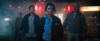 Movie still from “Venom” (2018), directed by Ruben Fleischer – A group of people standing in front of a wall; Medium shot, Low angle