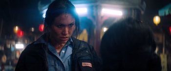 Movie still from “Venom” (2018), directed by Ruben Fleischer – A woman in a blue shirt and a black jacket; Close Up shot, Over the shoulder angle